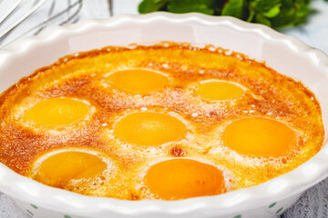 Peach Clafoutis in ceramic pie dish. Close up