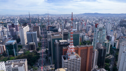 Obraz premium Aerial view of Av. Paulista in São Paulo, SP. Main avenue of the capital. With many radio antennas, commercial and residential buildings. Aerial view of the great city of São Paulo.