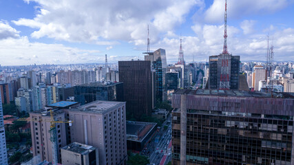 Fototapeta premium Aerial view of Av. Paulista in São Paulo, SP. Main avenue of the capital. With many radio antennas, commercial and residential buildings. Aerial view of the great city of São Paulo.