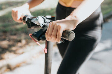 Close up of electric scooter handlebar pressing the brake and stopping.Rental application for...