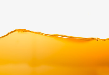 Vegetable oil surface, bubbles against white background.
