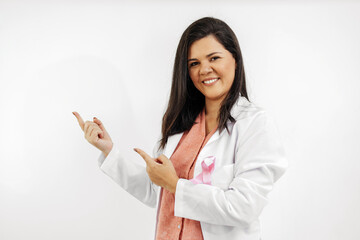 Young female doctor wearing a pink ribbon for breast cancer awareness