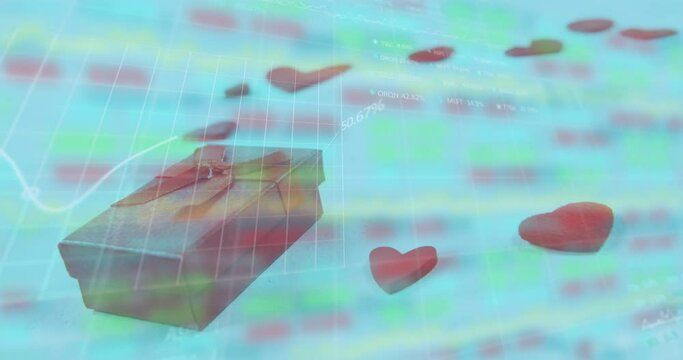 Animation of gift box and heart shapes over moving graphs and trading board