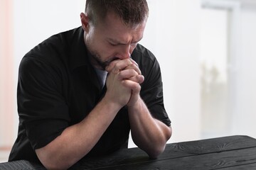 A Christ man prayers on dark background. Christian religion concept