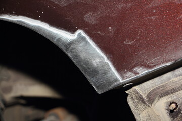 Car fender edge and wheel housing repair from rust. Sanded to metal car body detail