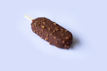 human hand on chocolate ice cream stick and nuts