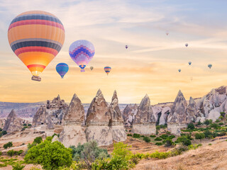 hot air balloons flying over fairy chimney valley with background of sunrise sky at goreme cappadocia turkey - obrazy, fototapety, plakaty
