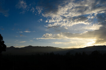 Sunset time photo of sun rays coming by penetrating the clouds after fresh rainfall