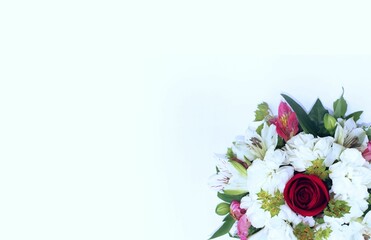 A festive bouquet with a red rose and white alstroemeria on a white background. View from above. Background for a greeting card.