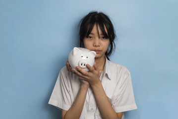 Fototapeta na wymiar child asian finance economic investment wealth pig currency money business banking, cash success saving girl holding coin piggy bank.