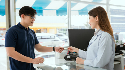 Pharmacist Chayong standing and talking to the patient Buying medicines with a credit card online spending