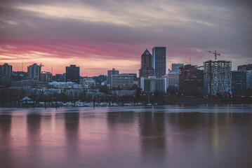 Fototapeta na wymiar The downtown city of Portland Oregon reflecting over the Willamette River waterfront at sunset