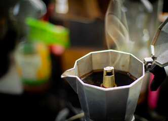 An image selected focus coffee with pot moka with smoke brew is a hot drink beverage espresso food energy for morning with copy space for text.