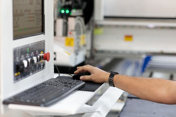 operator controls a modern woodworking CNC machine