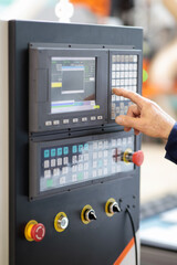 operator of CNC machine working with control panel
