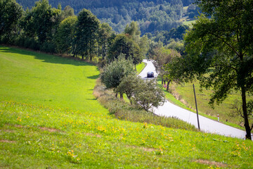 Road with car in National Park Sumava, Czech Republic.