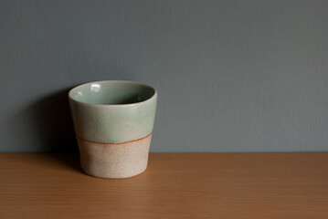 Asian ceramics tea cups on the wooden floor. Space for text.