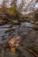 River in autumn with leaves and silk effect. Fall wallpaper