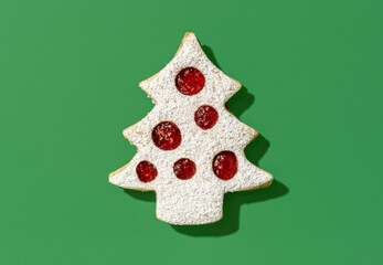 Christmas cookie with raspberry jam isolated on a green background