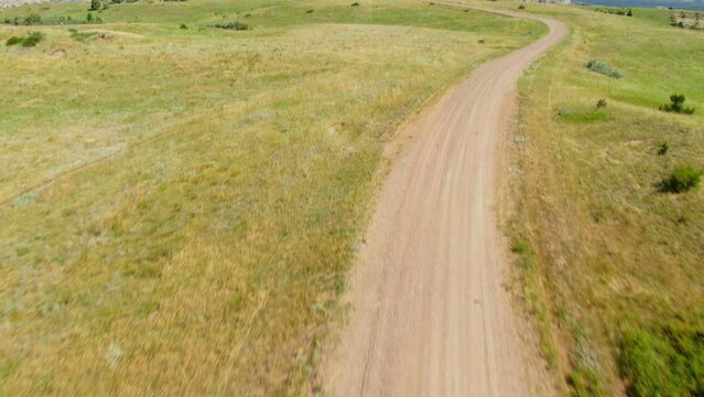 Farmer With UTV Tend The Red Angus Cattle Herd In Countryside Of Grassy Butte In North Dakota. - aerial