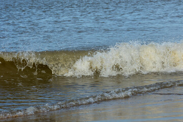 A spindrift wave close to the beach of the North Sea
