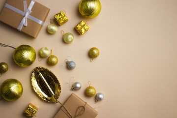 Golden ornaments with gift over the brown background. 