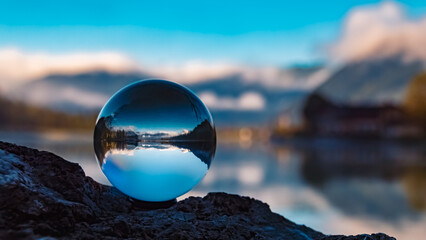 Crystal ball alpine landscape shot with reflections at the famous Pillersee lake at Saint Ulrich,...