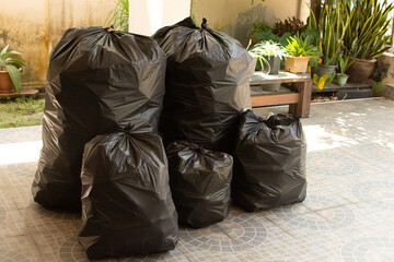 Pile of black garbage on the footpath at side road in big city 