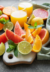 Glasses of juice and citrus fruits.