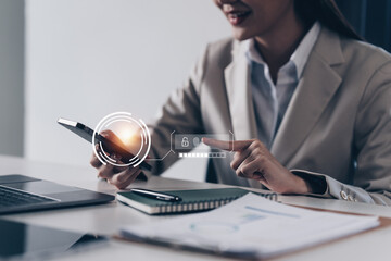 A business woman using fingerprint scan to cyber security for his saving account, business,...