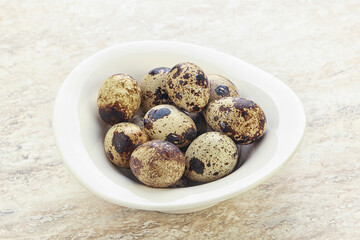 Raw quail eggs heap in the bowl