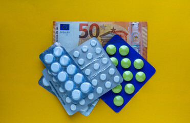 Euro banknote and pills. Medication costs. Price of medicines in Europe.