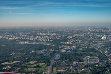 Aerial view photo from airplane of city and clear sky. aerial photo of large city from an airplane window. view of city of Moscow through window from plane