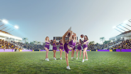 Group of cheerleaders in action on  stadium