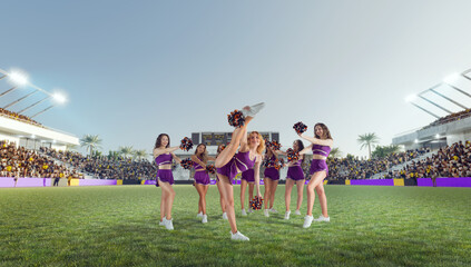 Group of cheerleaders in action on  stadium