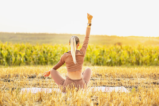 Yoga Meditation Wellness Woman Meditating On Morning Sunrise Nature Background In Peace And Zen Positive Attitude Panoramic Banner. Active Sport And Fitness Lifestyle Image.