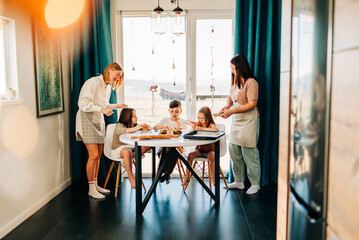 Big family with two moms cooking with their children cookies. Loving people and happy childhood hobbies