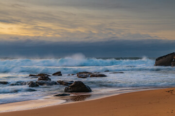 Cloud covered sunrise sesacape in soft pastel shades
