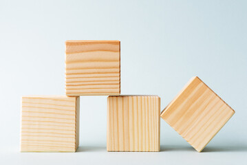 Four blank wooden cubes over blue background