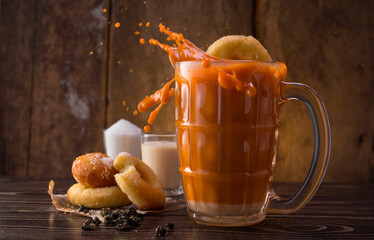 original hot thai milk tea drink with sweet donuts , thai beverage