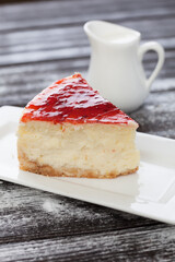 strawberry cheesecake and slice on table