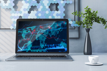 Close up of laptop computer with forex chart on screen. Designer office desktop background with coffee cup and flower. 3D Rendering.