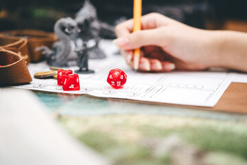 Focus on dice d20 in role playing tabletop and board games hobby concept