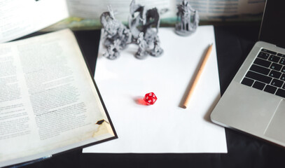 Behind of dungeon master screen with dice and miniatures for role playing tabletop and board games...