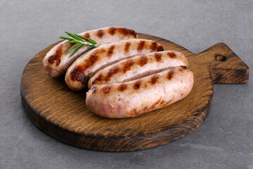 Grilled German, Munich, Bavarian, sausages on a wooden board.