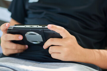 teen plays a game on a gadget