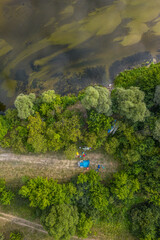 Kayaking and canoeing in the summer river. Aerial drone view on camping and river bank.