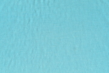 The texture of soft knitted cotton fabric is blue. An old tattered napkin.