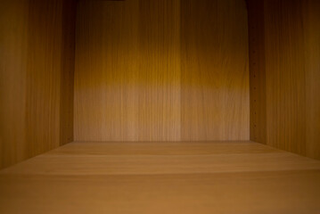 The display in the room decorated with wooden surfaces has empty spaces and shadows.