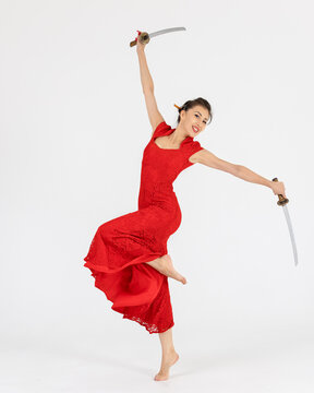 Aikido master woman in red dress with sword, katana on white background. Healthy lifestyle and sports concept.